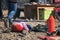 Pristine Mongolia. Mongolian Boy In Red Pants Sleeping On Stones Among Passing People During The Golden Eagle Hunters Festival. Ha