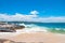 Pristine sand beach with distant city view