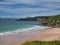 The pristine sand of Whiterocks Beach and coastal cliffs on the Antrim Causeway Coast in Northern Ireland, UK