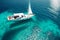 A pristine, white sailboat gliding on a calm, turquoise ocean