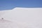 Pristine white sand dune contrasting blue sky