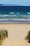 Pristine wild landscape at Clifton Beach in Tasmania, Australia with wavy blue ocean and golden sand