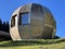 A private accommodation unit in the form of a large wooden ball or a glamping bungalow with a sauna by an alpine lake, Davos Dorf
