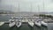 Private boats moored at yacht club dock, bad weather for sailing in open sea