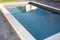 Private family home swimming pool with stone coping with grey waxed concrete terrace blue transparent water