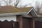 private garage under a tiled brown green roof