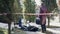 Private investigator entering crime scene with forensics scientist examining corpse. Young elegant Caucasian woman in