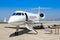 A private jet sits ready at the airfield.