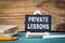 Private Lessons, education concept. small wooden board with chalk on the table