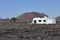 Private lonesome white bungalow in black volcanic lava landscape