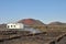 Private lonesome white bungalow in black volcanic lava landscape