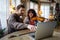 Private male music teacher giving violin lessons to a woman at home