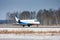 Private plane taxiing on the runway in a cold winter airport