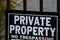 Private property no tresspassing sign printed in bold black and white letters