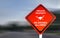 Private property sign, no drones allowed - red warning sign on a street, with speeding blurred background