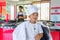Private Thai chef cooking, his little son in chef`s hat nearby s