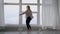 Pro modern dancer practicing in studio, blonde girl dancing indoor.