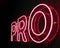 Pro red neon light letters on a black background