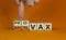 Pro-vax or anti-vax symbol. Doctor turns a cube  changes words \\\'anti-vax\\\' to \\\'pro-vax\\\'.