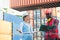 The Problem with businesswoman and engineer talking and checking loading Containers box from Cargo freight ship for import export