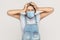 Problem, crisis, bad news or headache. Portrait of vexed young brunette woman with surgical medical mask in denim overalls