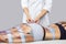 The procedure of myostimulation on the legs and buttocks of a woman in a beauty salon