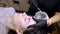 After the procedure of permanent eyebrow makeup, the master performs the waxing procedure applies wax to remove hairs to the
