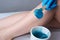 The procedure shugaring legs.the application of blue sugar paste.depilation in the salon