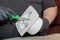 The process of assembling the kitchen exhaust fan after cleaning the wash. A man works with a screwdriver in his hands