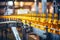 Process of beverage manufacturing on a conveyor belt at a factory.