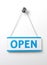 Process blue open door sign on a silver chain on a