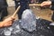 Process of breaking the ice with hammer and ice pick, group of people smashing shattered ice cube, team work success concept,