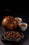 The process of brewing tea. Tea ceremony, Kettle and cups with a freshly brewed rosehip drink, dark mood