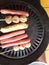 the process of burning sausage meatballs and fish rolls to become delicious food