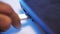 Process of charging device with a white USB cable. Media. Close up of male hands removing the white USB cable from a USB