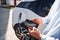 Process of charging is showing on smartphone. Close up view of man with his electric car