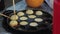 the process of cooking Japanese street food, takoyaki