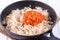 The process of cooking stewed cabbage with carrots and spices in a frying pan