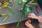 Process of creating a bouquet florist flower shop close-up. Woman hands and implement.