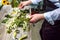 Process of creating a bouquet florist flower shop close-up. Woman hands and implement