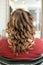 Process of creating a female hairstyle on long hair Hollywood wave view from the back