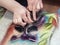 Process of creating a picture of wool. Contemporary art - felting wool, handmade. The painting -depicts the cheerful raccoon. The