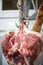 The process of cutting and chopping meat.