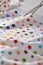 Process cutting fabric with a pattern of colorful stars by scissors on craft mat