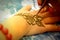 Process of drawing henna on hand, mehndi