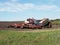 The process of filling the seeding machine on the tractor.