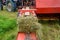 The process of harvesting hay for cattle, a tractor making bales in the field, old machinery