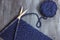 Process of knitting. Ball of blue woolen thread and knitting needle closeup on wooden