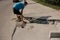 The process of laying sidewalk curb. Workers place a deflected piece of concrete curb into a