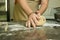 The process of making bread. The chef kneads the dough by hand